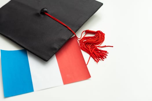 Graduation cap with red tassel isolated on white background. High quality photo