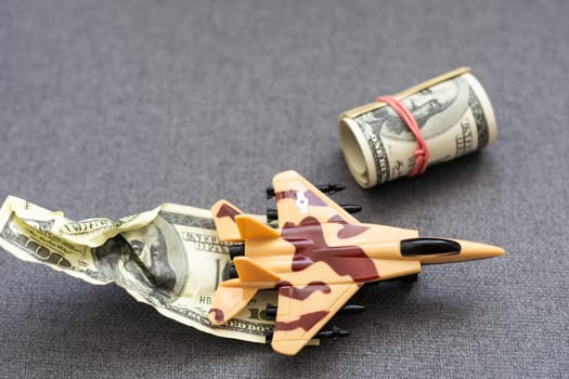 weapons on stacks of coins as a concept of the cost of military protection. High quality photo