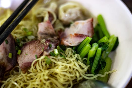 Egg noodle with wonton and red roasted pork. Asian food style.