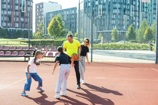 Time for family basketball. Family at basket playground. . High quality photo