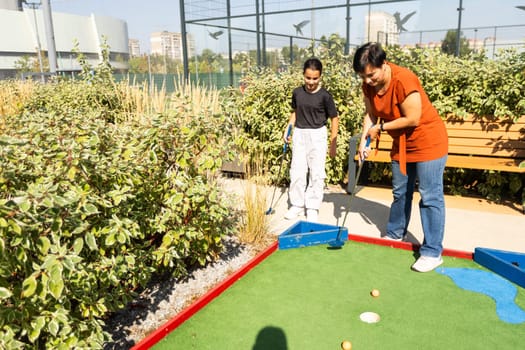 golfers with parents playing golf at sunny day. High quality photo