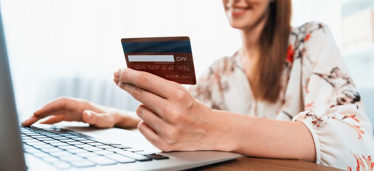 Close up credit card using for online payment, banking and shopping on the internet network with laptop computer showing credit card technology for online secured wallet top up and utmost purchase