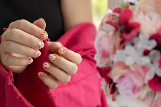 Woman manicured hands, stylish summer colorful nails. Closeup of manicured nails of female hand. Summer style of nail design concept. Beauty treatment.