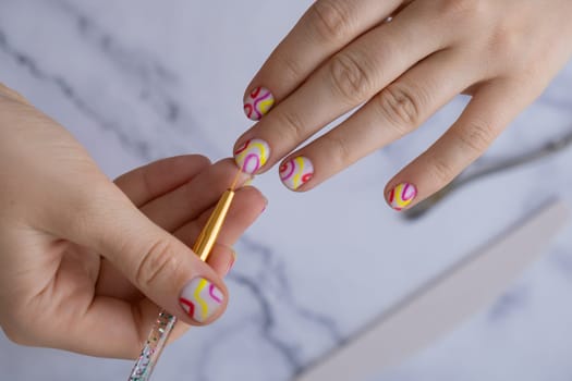 Manicured tools Woman manicured hands, stylish summer colorful nails. Closeup of manicured nails of female hand. Summer style of nail design concept. Beauty treatment.