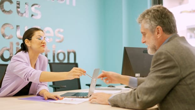 Business woman giving the pen to a client to sign the contract