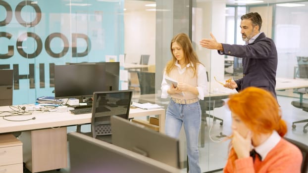 An angry boss shouting at a employee and fire her in front of colleagues