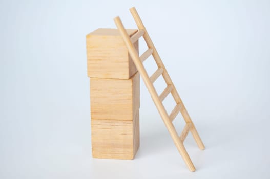 Wooden cubes with ladder on white background with customizable space for text