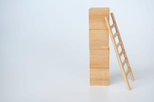 Wooden cubes with ladder on white background with customizable space for text.