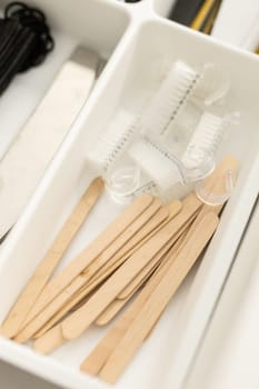 Manicure and pedicure tools. Nail file and cuticle pusher orange wood sticks. Top view.