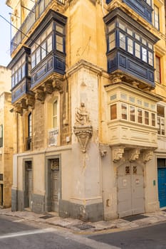 Valletta, Malta, April 03, 2024.  the typical religious statues at the corners of the ancient buildings and the city centre