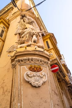 Valletta, Malta, April 03, 2024.  the typical religious statues at the corners of the ancient buildings and the city centre