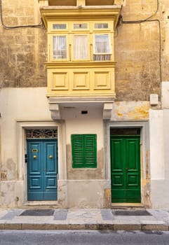 Valletta, Malta, April 03, 2024.  external view of the typical entrance doors of houses in the city center