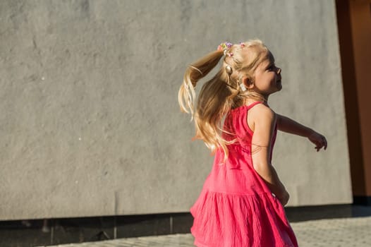 Child with hearing problem and cochlear implant dance in street, deaf kid began to hear. Hearing loss in childhood and treatment concept. Copy space and empty place for text.