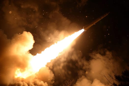 Long range rocket launch at night with fiery exhaust trail and smoke plumes. Concept of space exploration, military power or scientific research