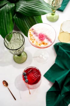 Two refreshing summer cocktails with lemon, mint, cranberry on a table. High quality photo