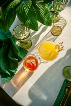 Two refreshing summer cocktails with lemon, mint, cranberry on a table. High quality photo