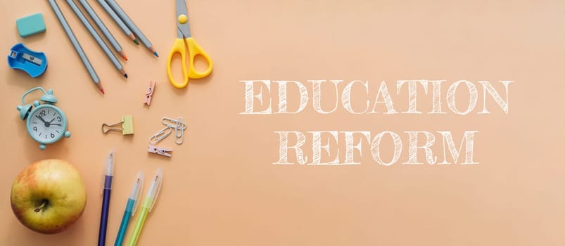 A banner with a bunch of school supplies and a clock on it that says Education Reform. The banner is on a tan background