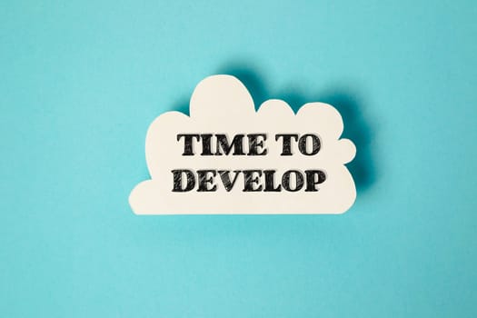 A white cloud with the words Time to Develop written in black. Concept of growth and progress, as the cloud represents the potential for change and development