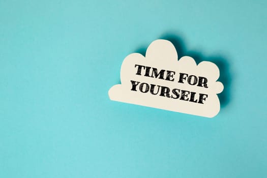 A white cloud with the words time for yourself written on it. Concept of relaxation and self-care