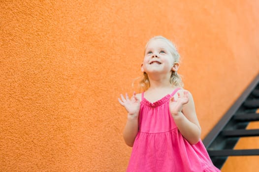 Child with hearing problem and cochlear implant dance in street, deaf kid began to hear. Hearing loss in childhood and treatment concept. Copy space and empty place for text.