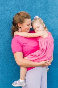 Child girl with cochlear implant with her mother spend time outdoor. Hear impairment and deaf community concept. Deaf and health concept. Diversity and inclusion. Copy space.