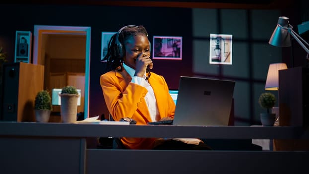 African american girl listening to professor debating latest lesson, taking notes after understanding explanations. Student participating at online school classes on academic platform. Camera B.