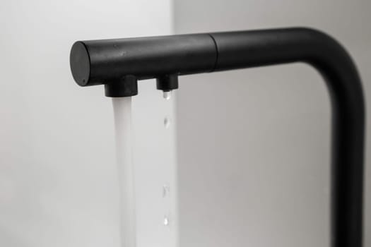 Water flows from the black tap in the kitchen.