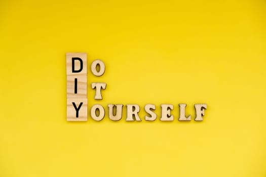 DIY Do It Yourself inscription on yellow background. Handmade home repair decorating handicraft. Tactile creative hobby concept me-made manual activities