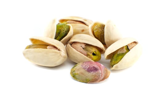 Pistachios in-shell and others peeled exposing the green nuts inside isolated on white background
