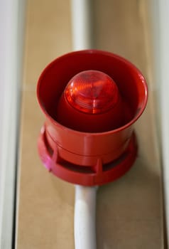 Emergency, siren and speaker for fire alarm, warning and evacuation with safety regulations or compliance. Red light on wall for security alert, noise and danger with sound, electricity and risk.