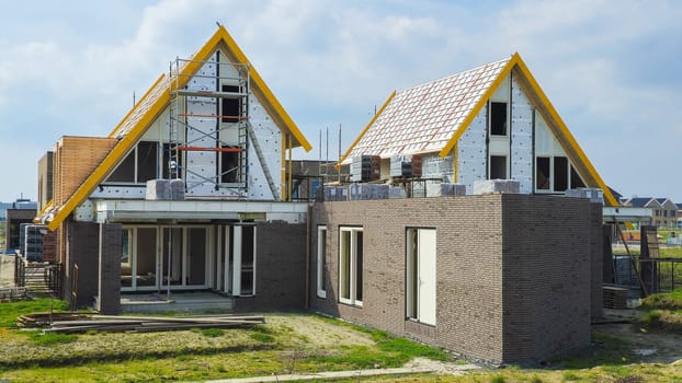 construction site of a new Dutch Suburban area with modern family houses, newly built modern family homes in the Netherlands