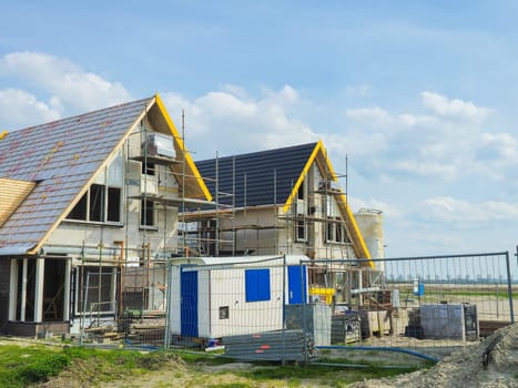 construction site of a new Dutch Suburban area with modern family houses, newly built modern family homes in the Netherlands during construction