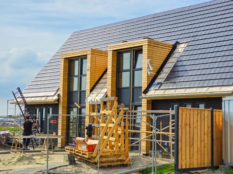 construction site of a new Dutch Suburban area with modern family houses, newly built modern family homes in the Netherlands , new prefab house construction