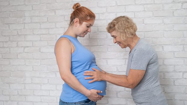 Elderly woman and her adult pregnant daughter