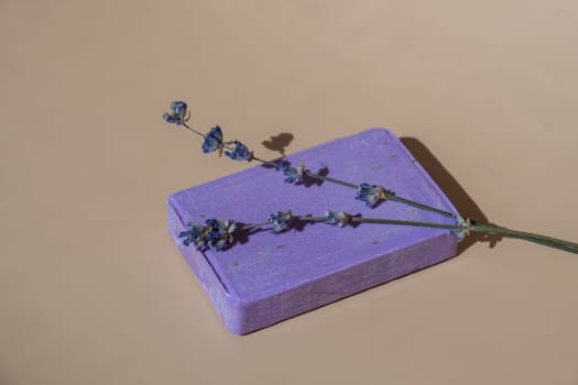 Handcrafted purple lavender soap with lavender flowers. Natural hydrating moisturiser softness cosmetic. Organic calming beauty skincare product. Herbal self care wellness alternative soap. Copy space