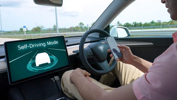 Self driving car or autonomous vehicle travel on speed highway with driverless system and autopilot mode allowing man driver relax and focus on smartphone without compromising safety. Perpetual