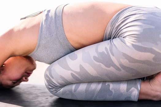 unrecognizable young asian woman in sportswear practicing yoga, relaxation and healthy lifestyle concept