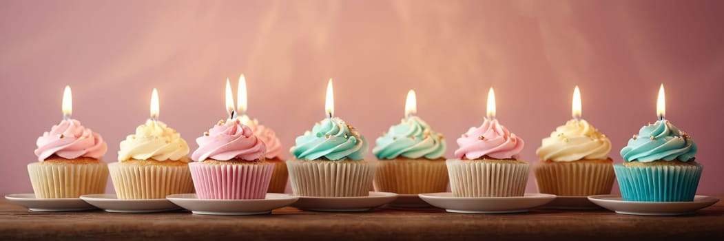 Colorful cupcakes with lit candles are displayed against a pink background, indicating an indoor celebration event marking of joy and celebrating. with free space.