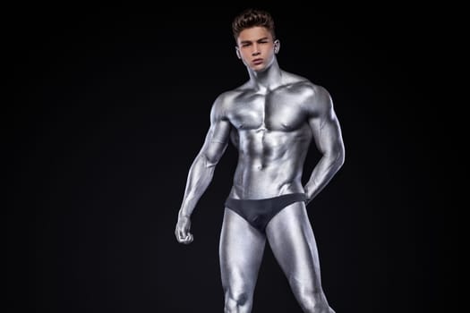 Man with conceptual slver body art.