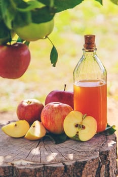 Apple cider vinegar in the garden. Selective focus. Food.