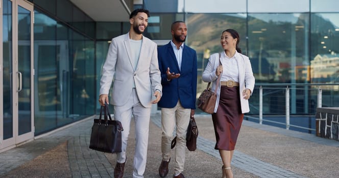 Business people, group and conversation in city on walk for commute to workplace with questions by buildings. Men, woman and employees with bag, outdoor and discussion for travel on metro sidewalk.