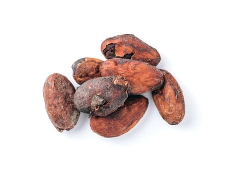 Raw cacao beans top view on white background. Close up view of raw cacao beans isolated on white with clipping path.
