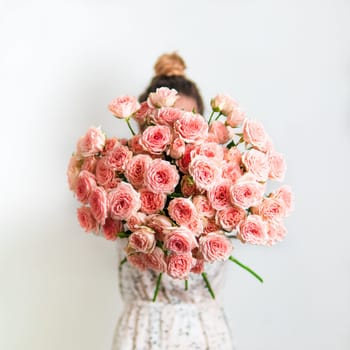 Close up view of nice subtle delicate pink bouquet with roses, dianthus, hypericum, clove. Shallow DOF. Copy space for text.