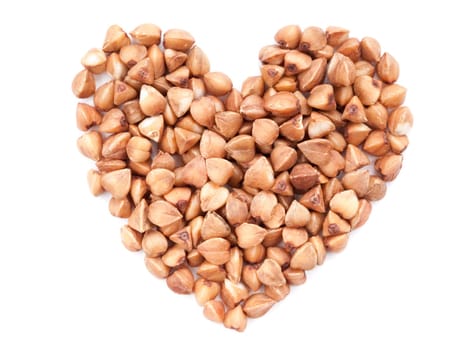 Background of heart-shaped buckwheat. Isolated on white. Top view or flat lay. Healthy food and diet concept