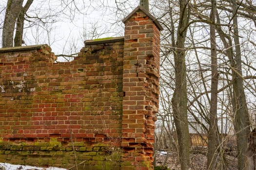 old red brick fence is crumbling and destroyed