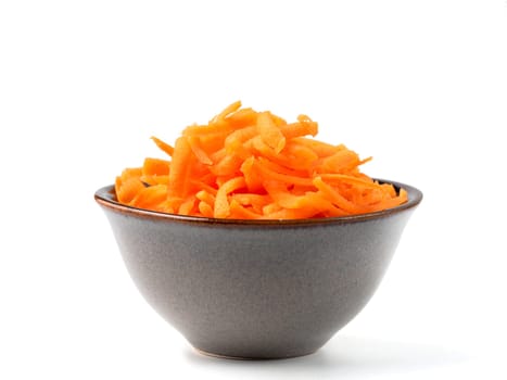 Fresh organic shredded carrots in small white bowl. Raw grated carrots isolated on white with clipping path.