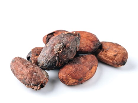 Raw cacao beans top view on white background. Close up view of raw cacao beans isolated on white with clipping path.