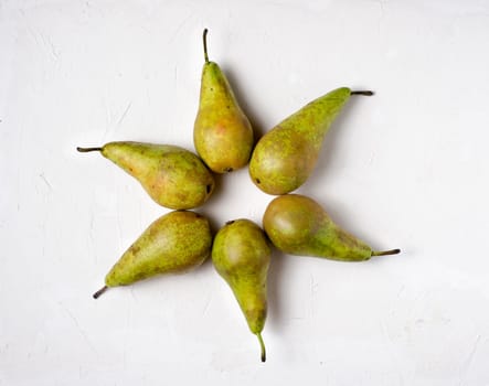 Pear on white background. Sun or star shape from pears on white textured background. Summer or healthy concept.