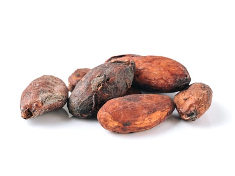 Raw cacao beans top view on white background. Close up view of raw cacao beans isolated on white with clipping path.