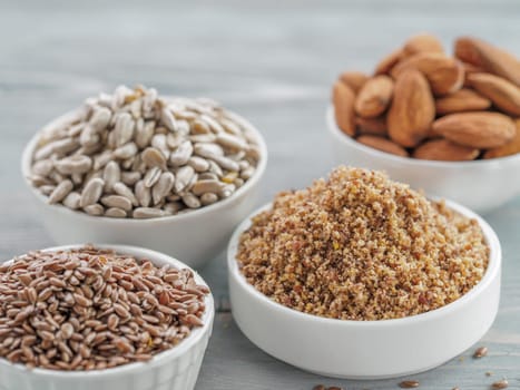 Homemade LSA mix in plate and Linseed or flax seeds, Sunflower seeds and Almonds. Traditional Australian blend of ground, source of dietary fiber, protein, omega fatty acids. Copy space for text.